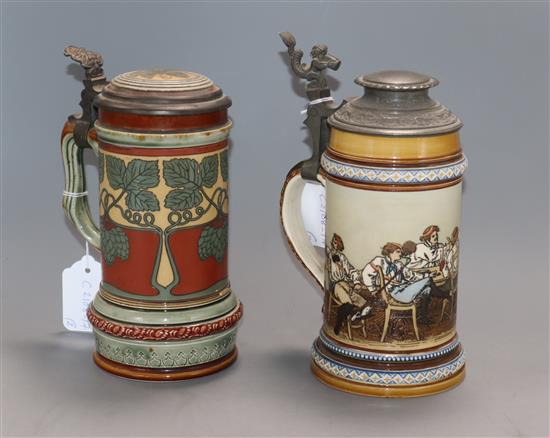 A Mettlach stein decorated with topers and another with hops